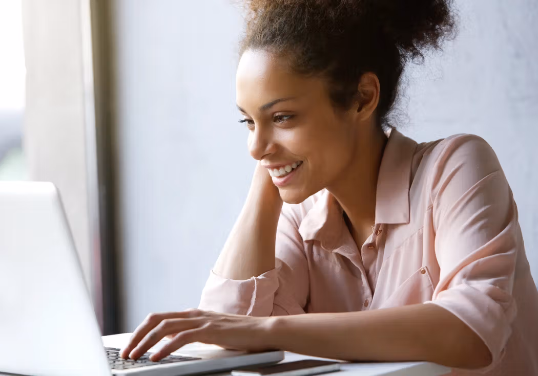 Woman using a laptop to review dental insurance options