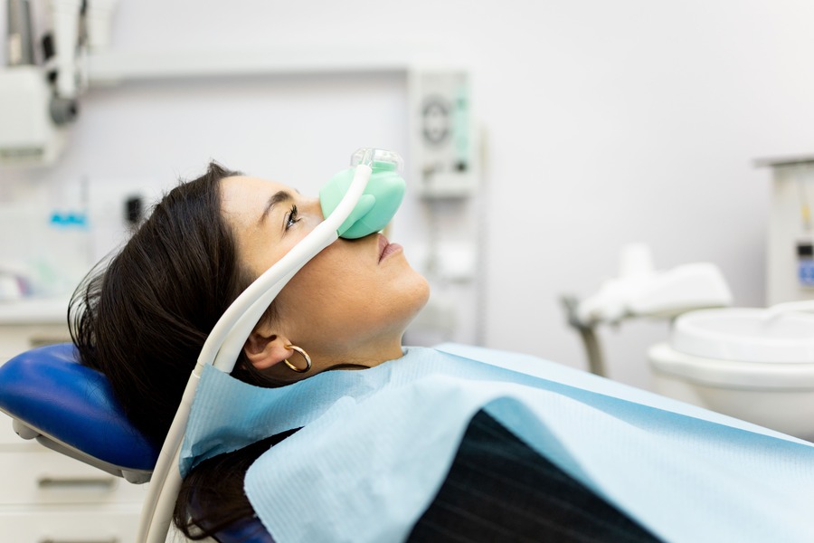 Patient receiving nitrous oxide sedation in a dental chair