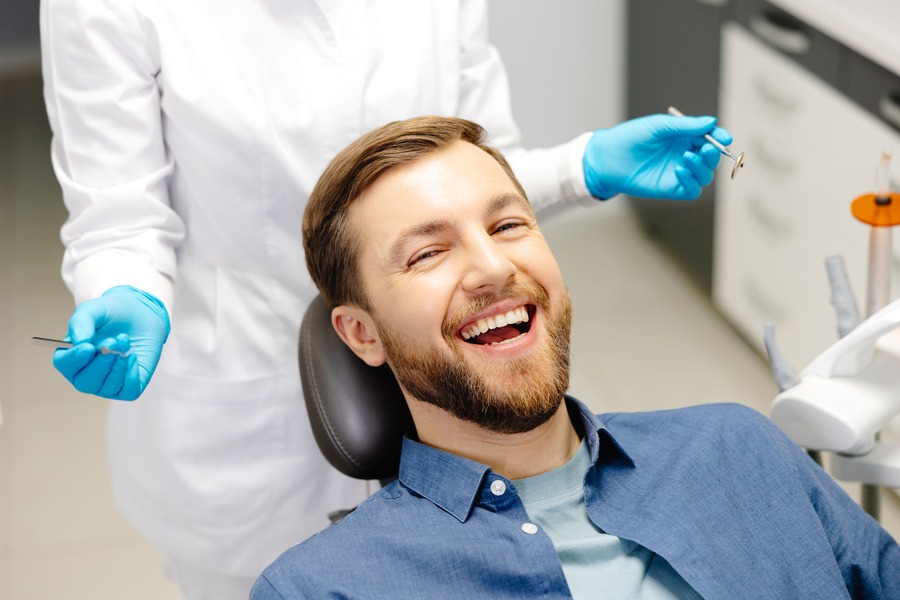 Patient smiling after emergency dental care
