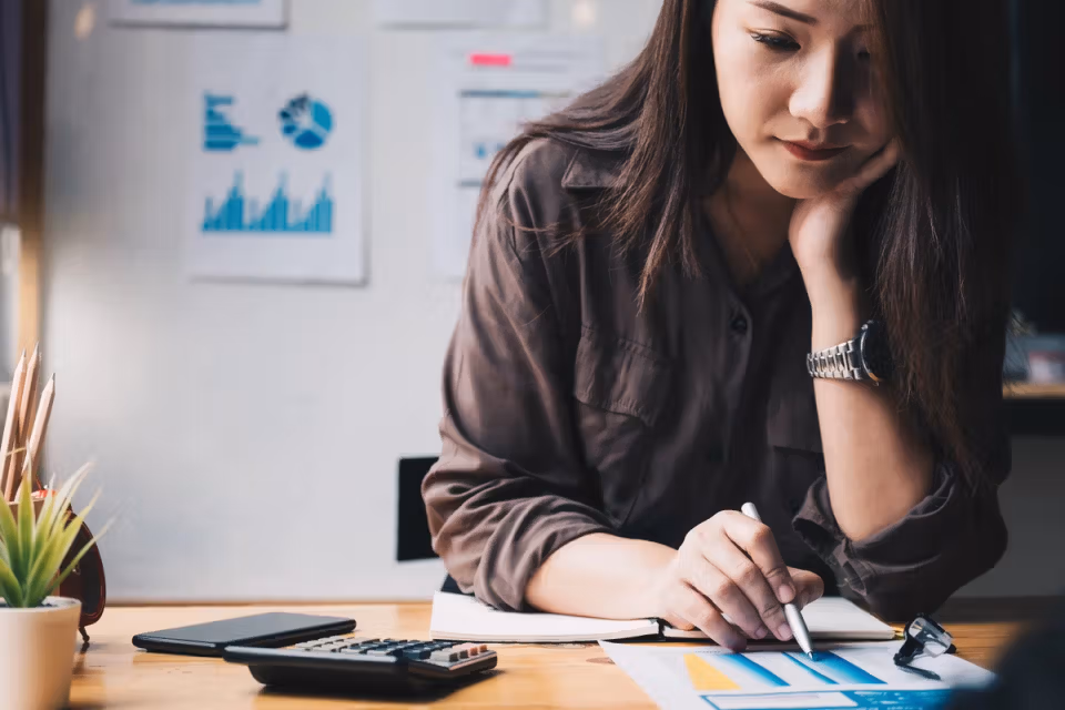 Woman reviewing payment documents at a desk