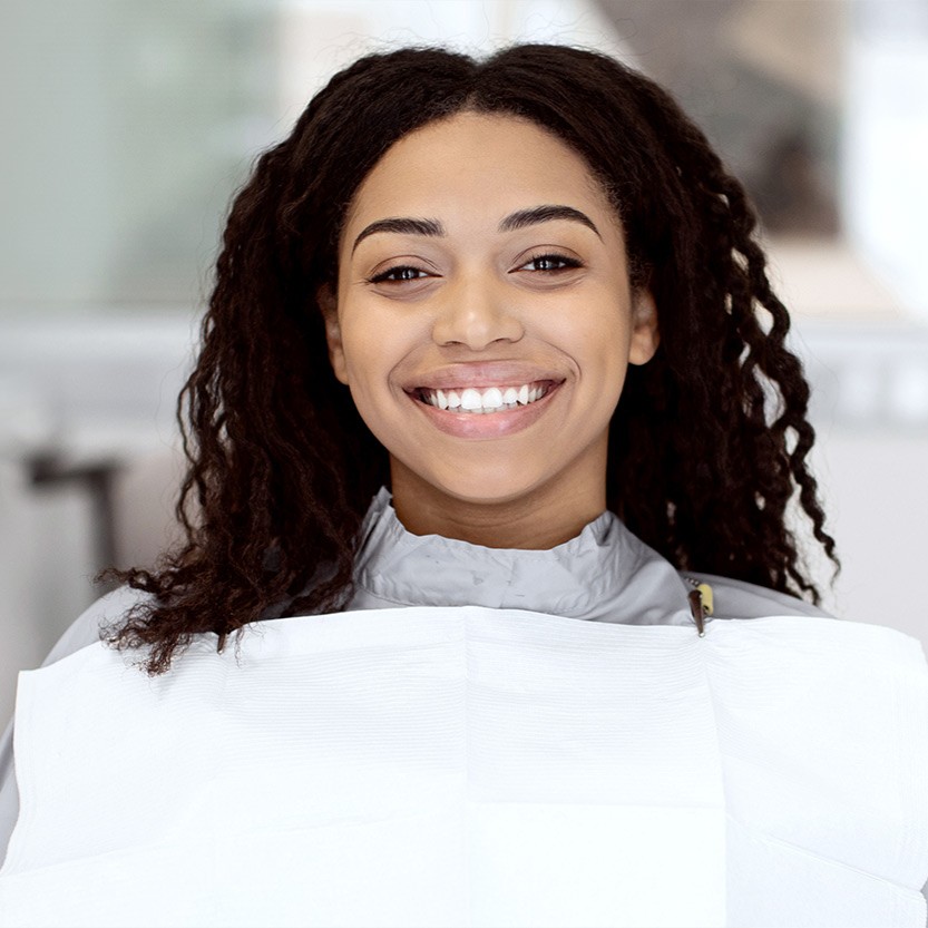 Smiling patient seated in a dental chair